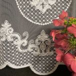 Stylish curtain with cream-colored embroidered ornamental 